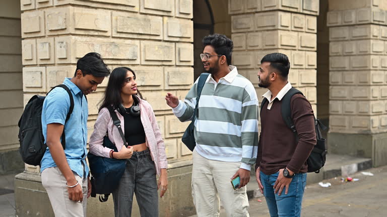 Commerce students talking outside a college building